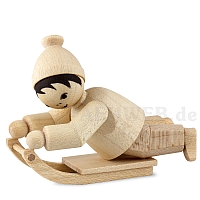 Child lying on sledge natural wood