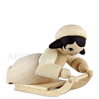 Girl lying on sledge natural wood