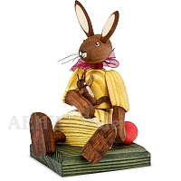 Easter bunny girl sitting with yellow dress and doll